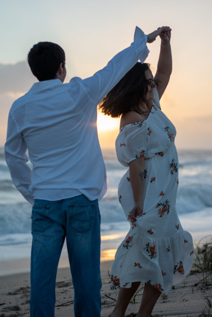 Couple dancing on the beach at sunset during Hawaii elopement