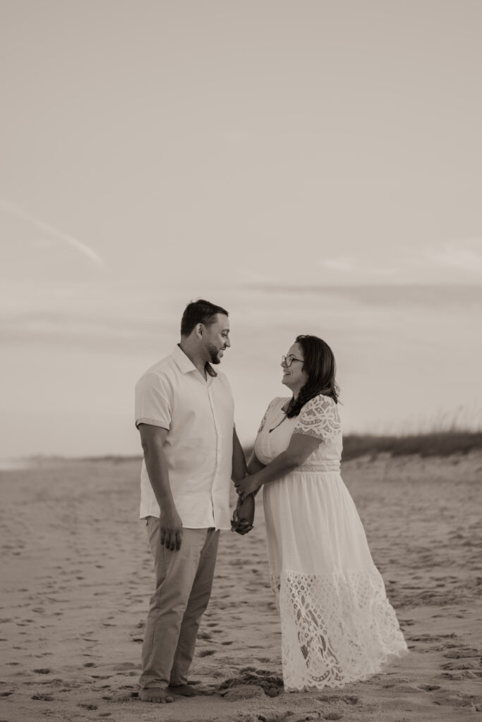 Couple on the beach during engagement photoshoot; beach elopement