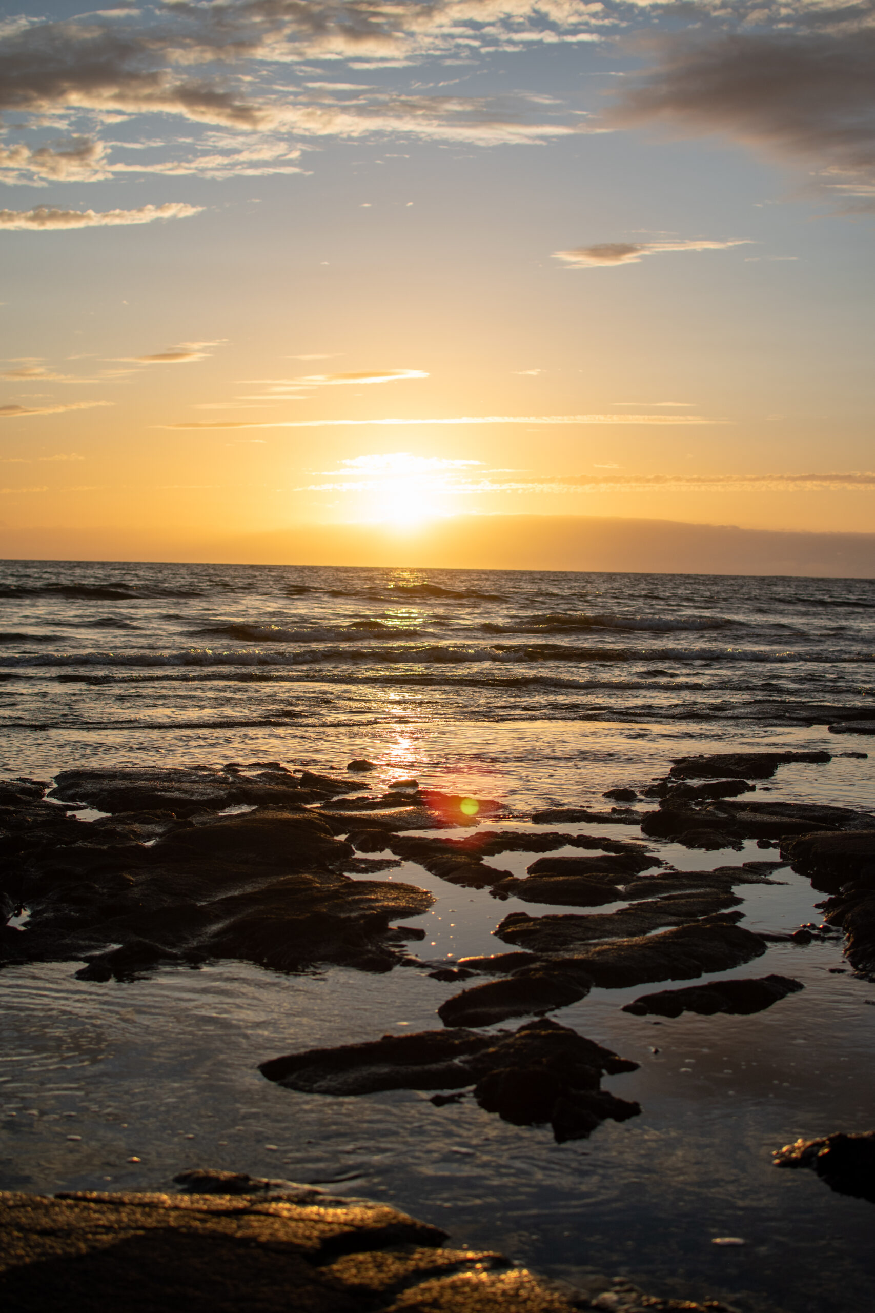 Sunset on a lava rock beach in Kona, Hawaii. Perfect for a Big Island Elopement