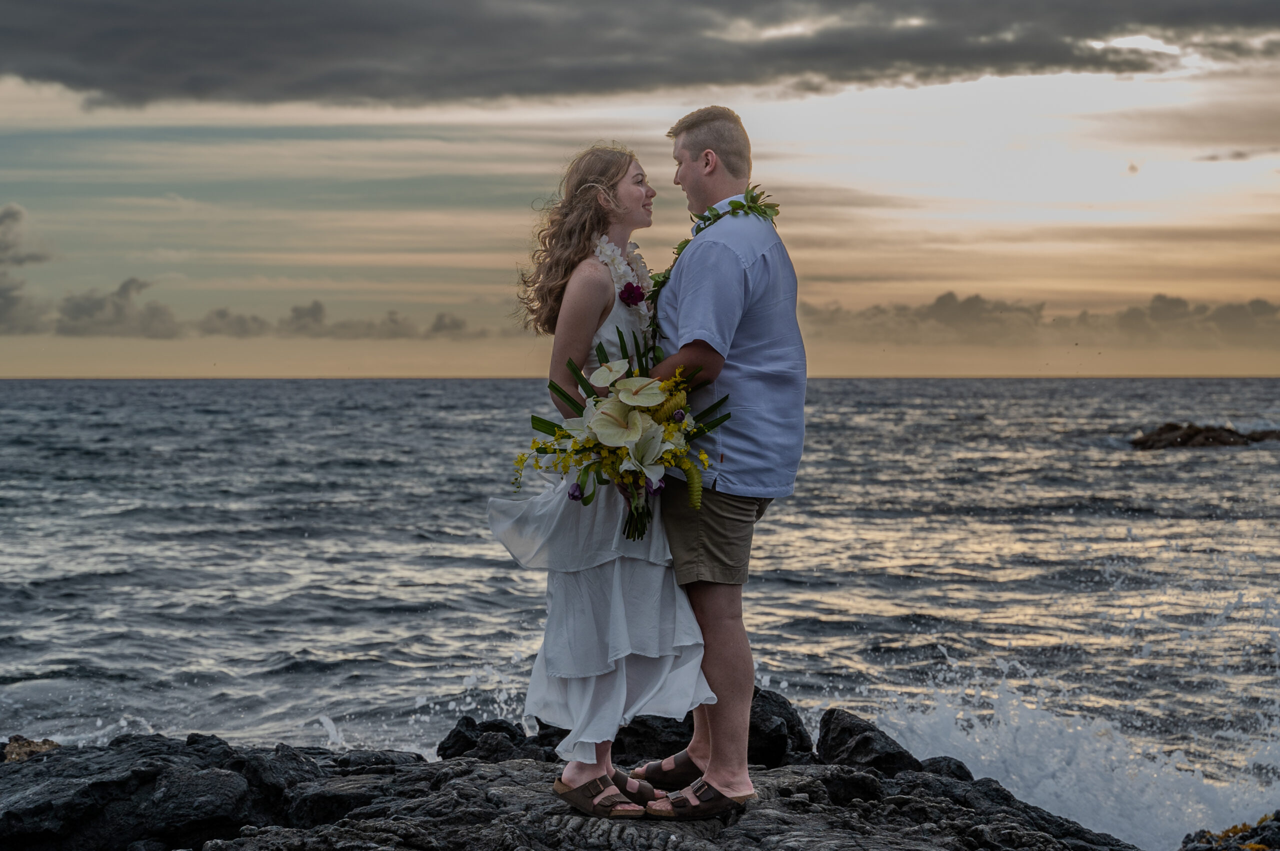 Eloping couple at sunset on lava rocks in Kona, Hawaii