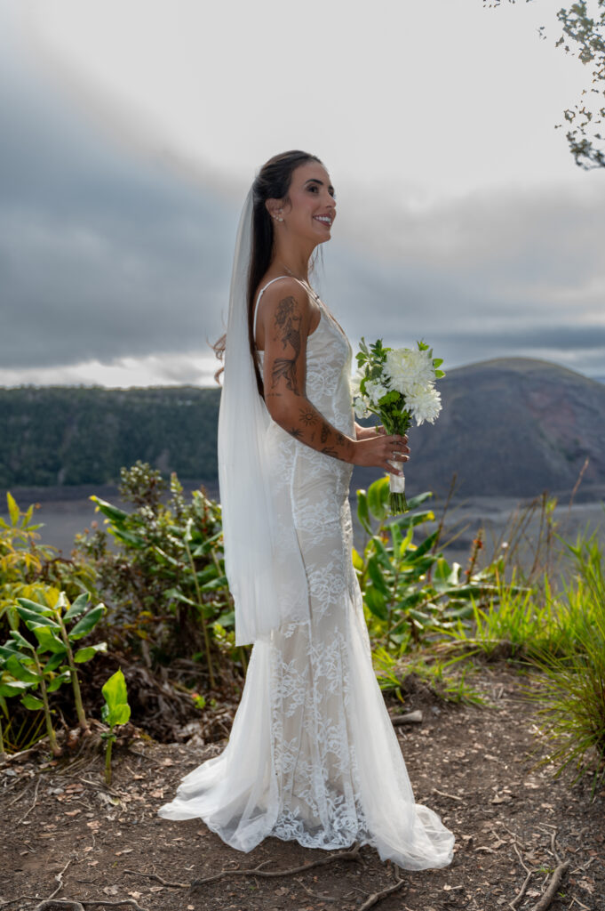 A beautiful couple elopes on in the lush green forest of Hawai'i's Volcano National Park