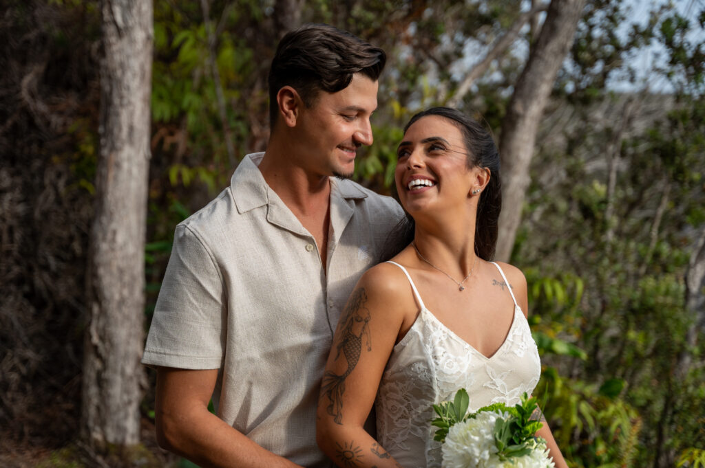 A beautiful couple elopes on in the lush green forest of Hawai'i's Volcano National Park