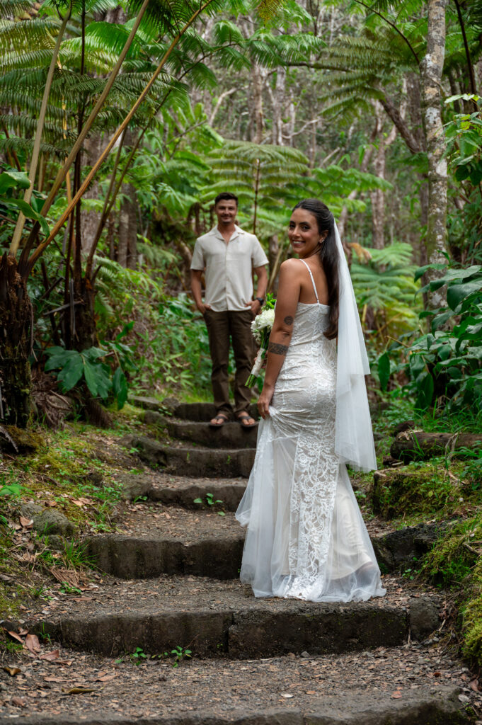 A beautiful couple elopes on in the lush green forest of Hawai'i's Volcano National Park