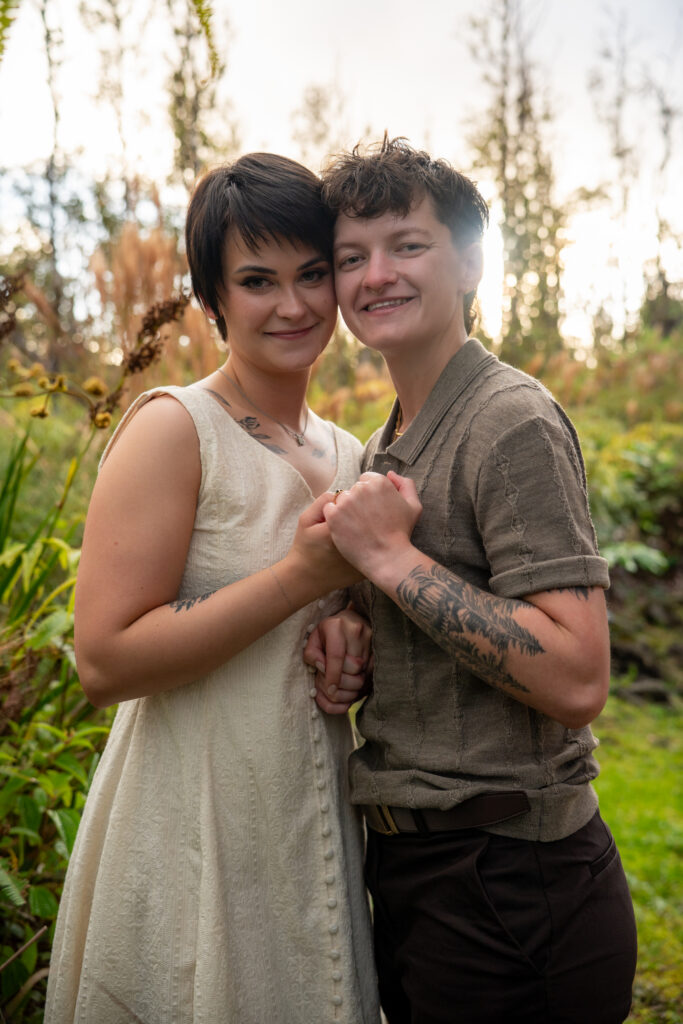 A couple embraces while facing each other and smiling
