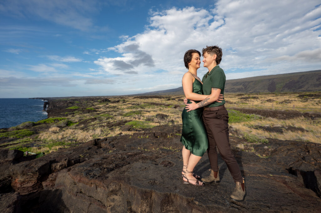 A couple stands on a gigantic lava flow