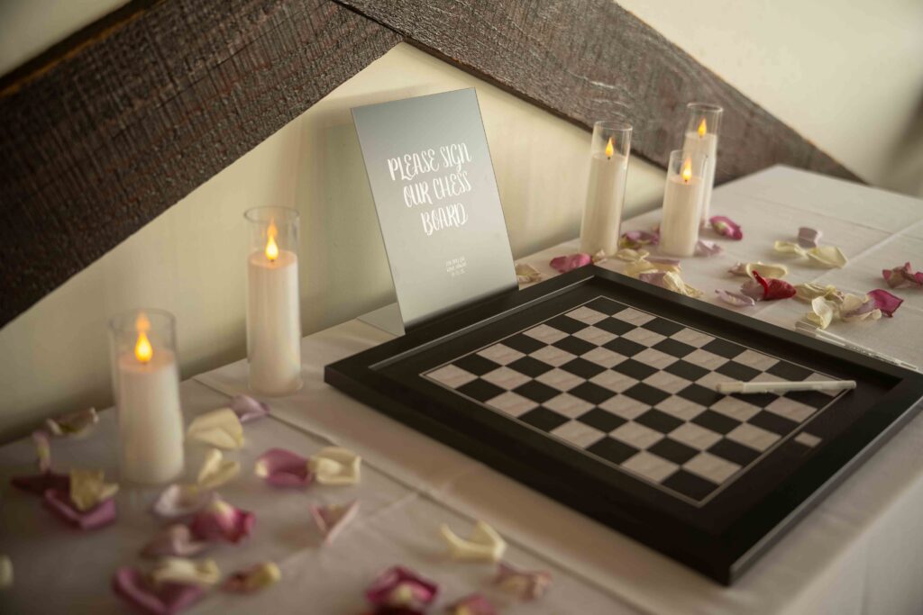 A chessboard is used as a guest book at a Papa Kona wedding