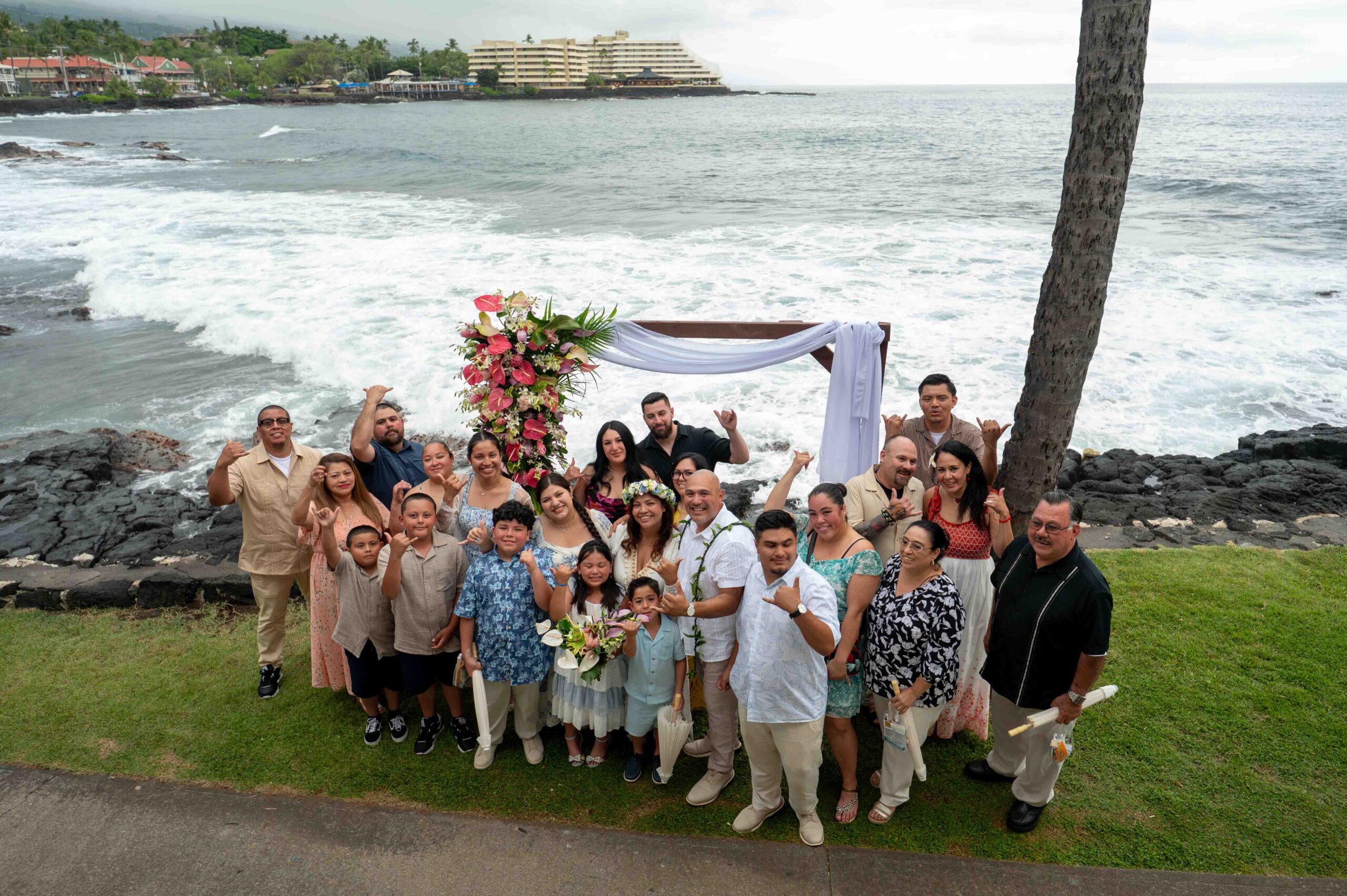 A family poses for a photo after a Papa Kona Wedding
