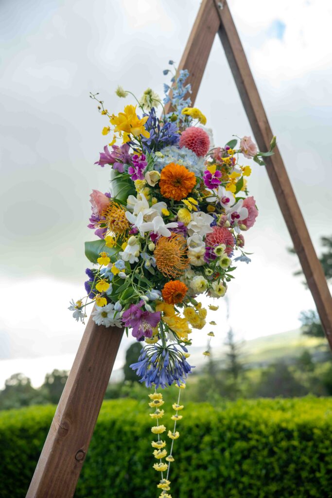 Spring flowers on a triangular wedding arch