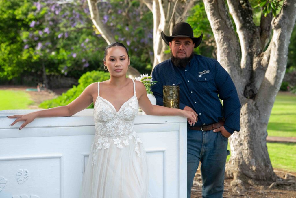 A wedding couple stands near the bar during cocktail hour
