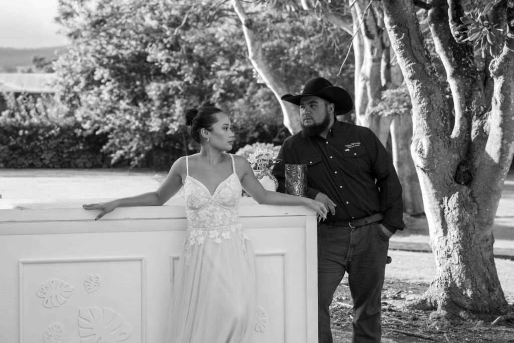 A wedding couple stands at the bar during cocktail hour