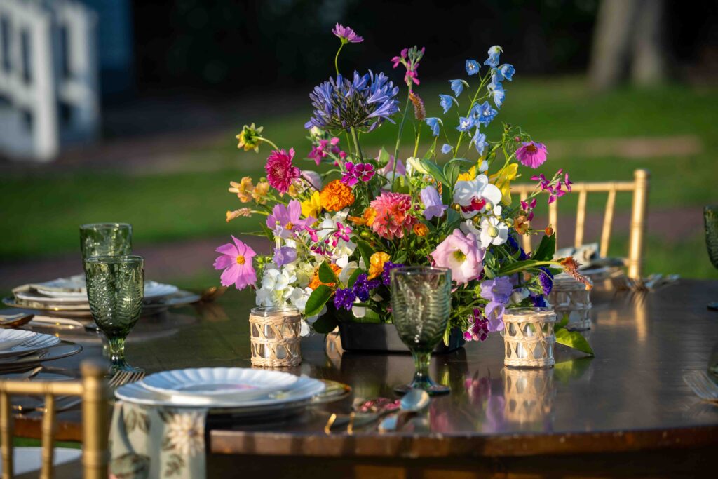 A floral arrangement on a decorated wedding reception table