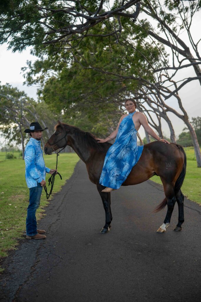 A woman sits on her horse while her husband holds the reins