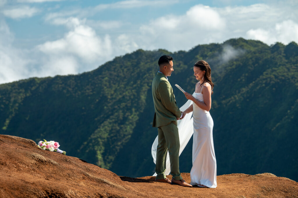 A bride reads her vows during a Kauai elopement at Kalalau lookout