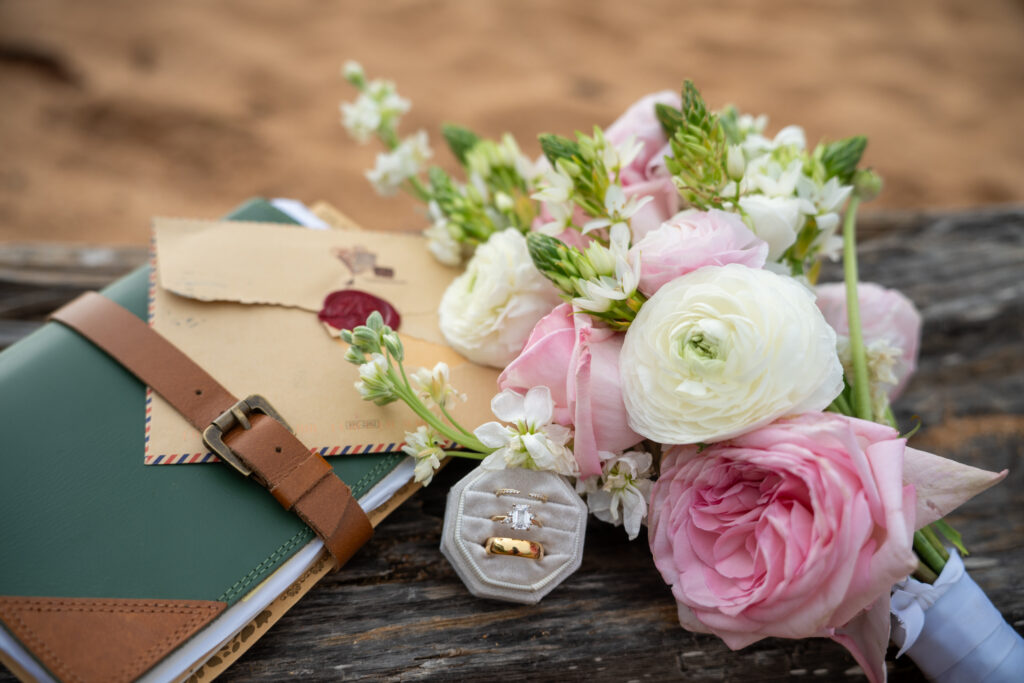 details from a Kauai elopement including a bouquet, wedding rings and letters the couples wrote to each other