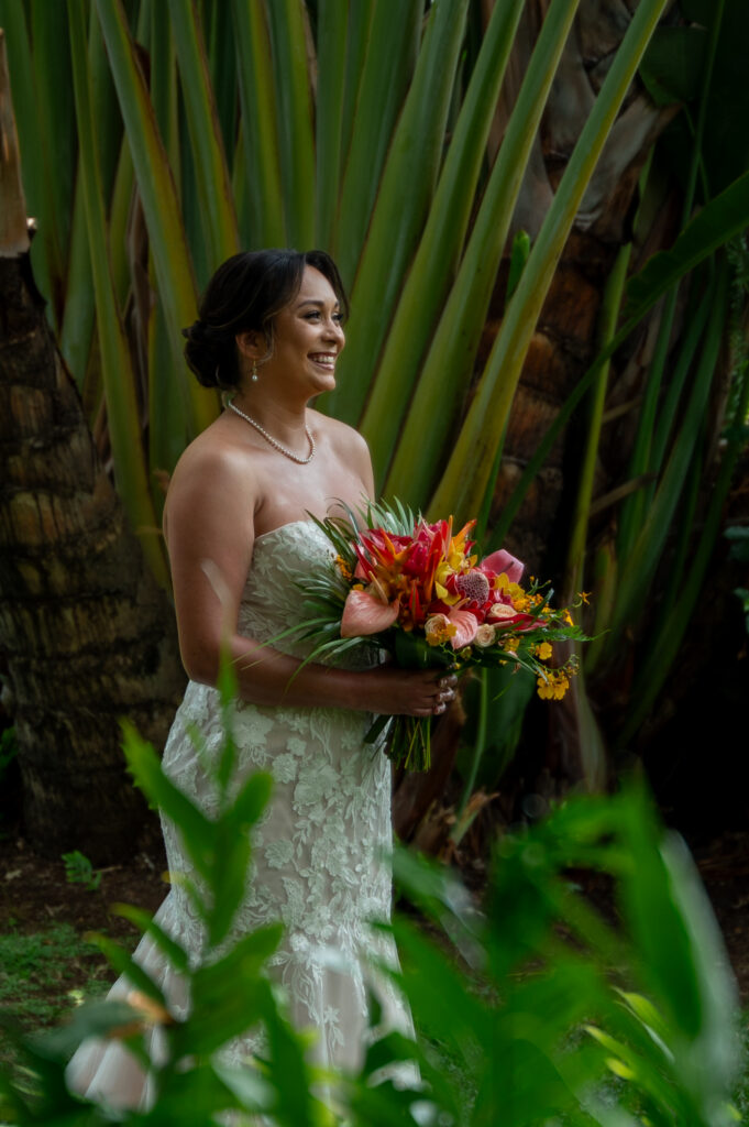 A bride and groom have a private first look in the gardens before their Outrigger Kona wedding