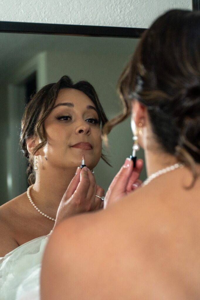 A bride gets ready in her hotel room before her Outrigger Kona wedding