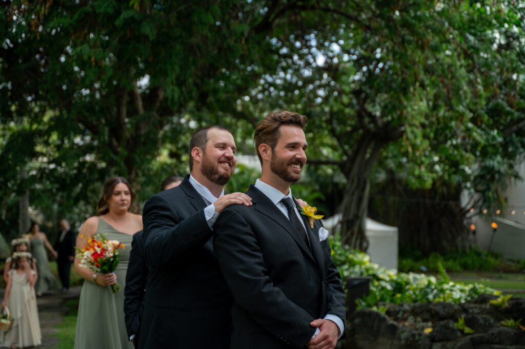 A groom stands with his best man just before entering the chapel at his Outrigger Kona wedding