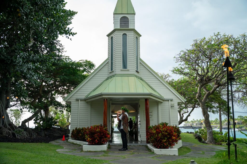 Kahu Tom blows the conch shell outside the chapel at an Outrigger Kona wedding