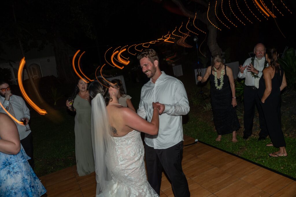 A bride and groom dance in the Helani gardens at their Outrigger Kona wedding