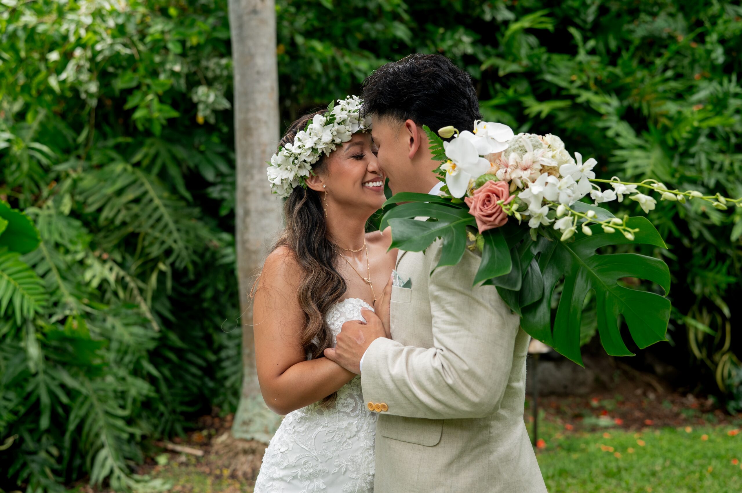 A bride and groom have a private first look in the gardens before their Outrigger Kona wedding