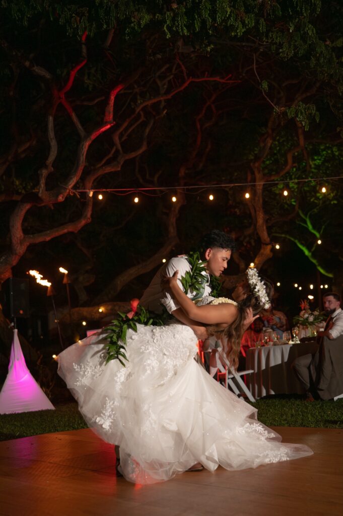 A bride and groom dance together in Helani gardens at their Outrigger Kona wedding
