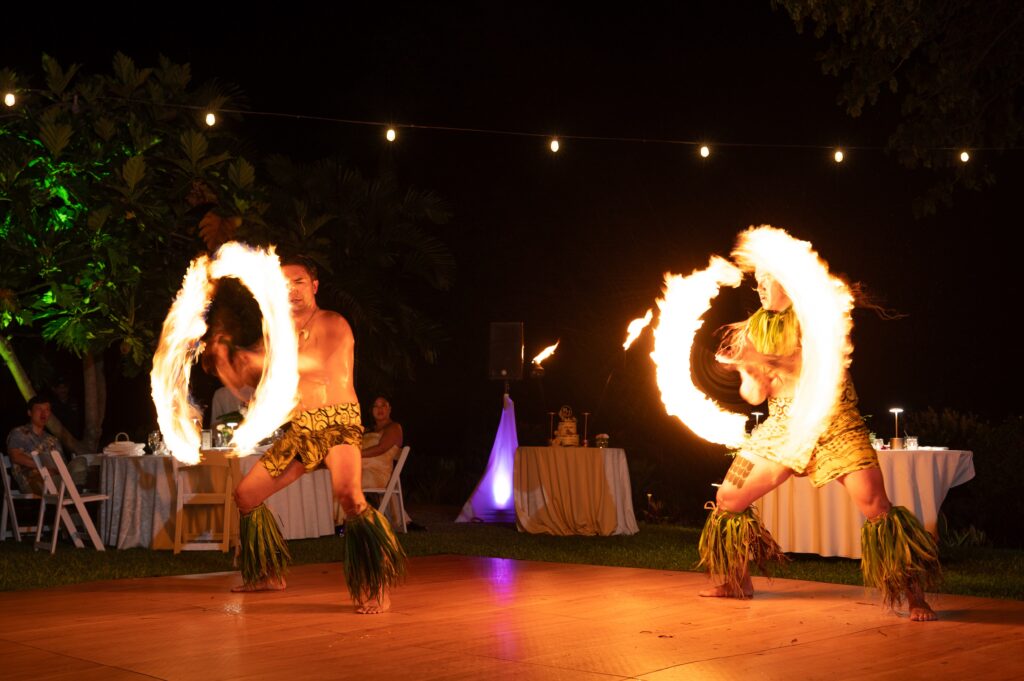 Two fire performers during a reception in the Helani gardens at an Outrigger Kona Wedding